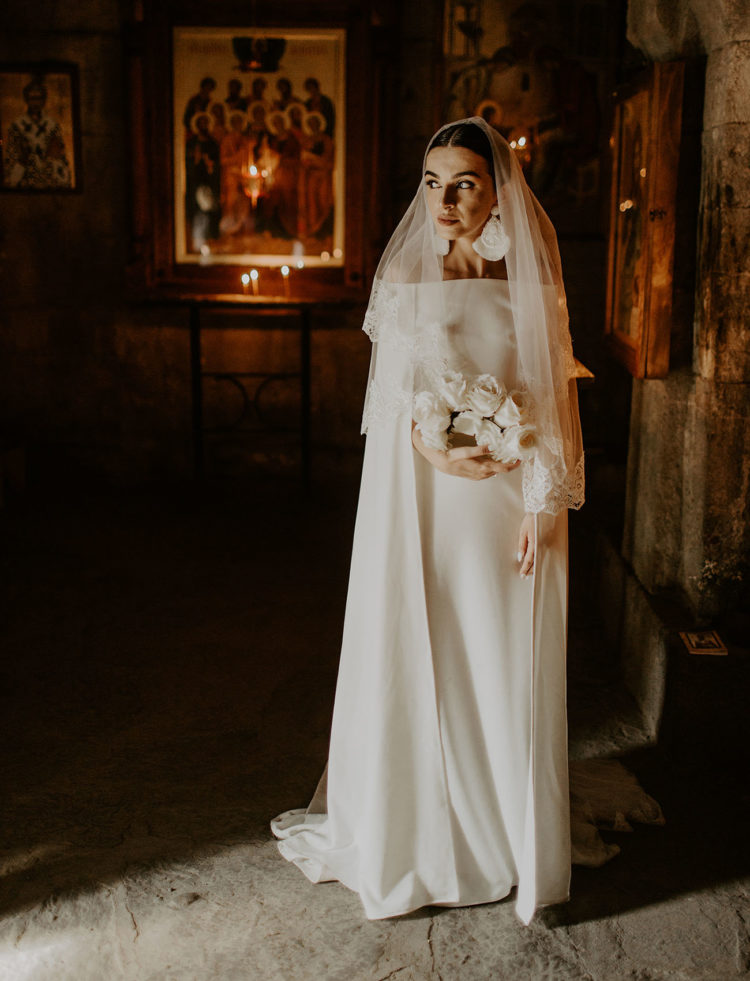 The bride was wearing an amazing modern off the shoulder dress with long sleeves, a layered veil and statement earrings