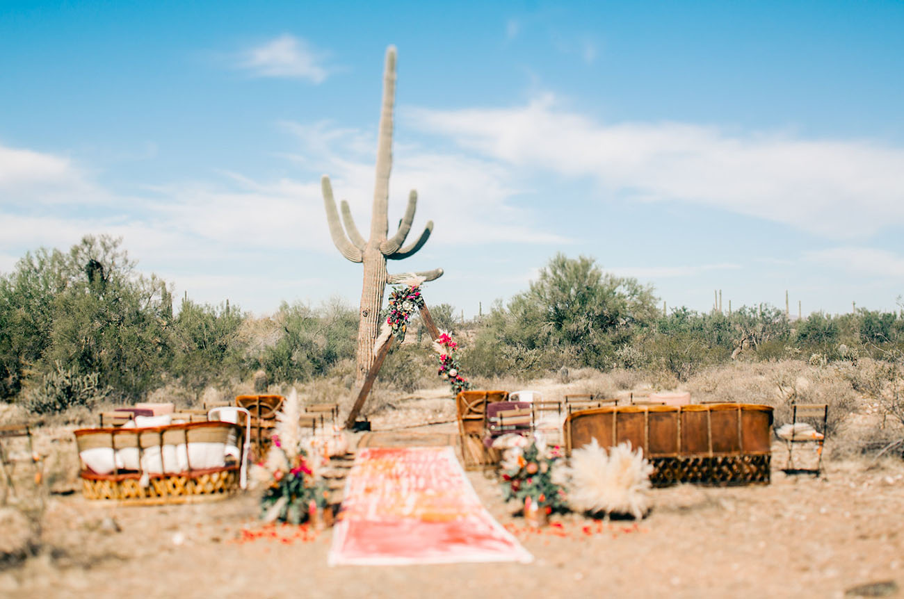 The ceremony space was a very boho one, with a colorful runner, pampas grass and bold flowers