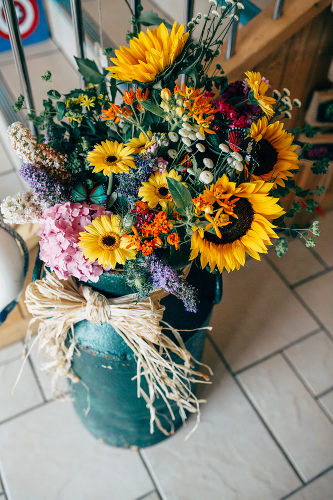 The florals were rustic and colorful, bought directly and then arranged by the maid of honor