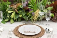 03 a lush tropical table runner of various types of greenery and leaves for a trendy no bloom look