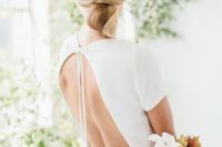 03 a sleek minimalist twisted low updo with a sleek top is ideal for a minimalist bride