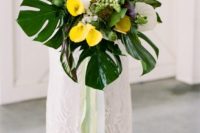 04 a bright bouquet with white and yellow callas and monstera leaves plus ribbons