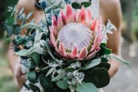 04 a gorgeous bouquet with a king protea, eucalyptus, blue thistles and some pale herbs for a tropical bride
