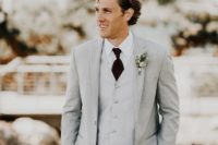 05 The groom was rocking a light grey three-piece wedding suit with a burgundy tie