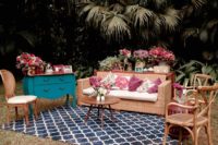 05 The wedding lounge was done with rattan furniture and lots of bold blooms