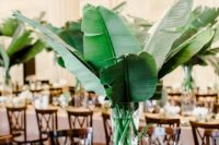 05 a modern centerpiece with large banana leaves and a clear vase – DIY them all