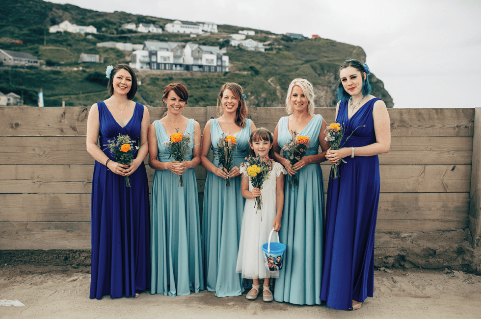 The bridesmaids were wearing aqua and bold blue thick strap dresses with V necklines