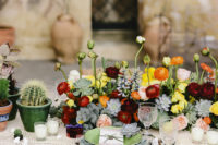 07 The wedidng tablescape was done with bright florals, a macrame tablecloth, candles and cacti