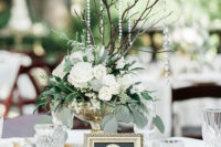 08 The wedding reception tables were done wih white roses, greenery, hanging crystals and gilded touches