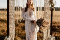 08 a boho lace wedding dress with a cutout neckline, long bell sleeves and a train