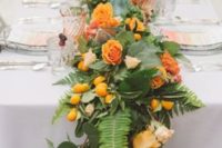 08 a lush greenery tropical runner with citrus and orange blooms to match