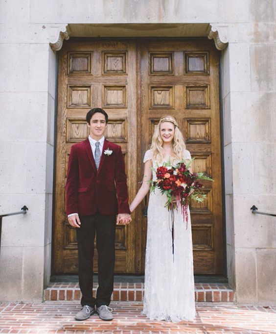 a marsala velvet jacket makes up the whole groom look adding a bold touch to the outfit