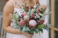 08 a summer wedding bouquet with king proteas, greenery, berries and seeded eucalyptus for a creative look