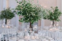 08 tall greenery centerpieces in clear glass vases, with olive branches and eucalyptus look very chic