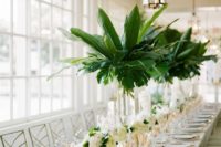 09 tall centerpieces in clear glass vases with palm leaves are great for a southern or tropical wedding