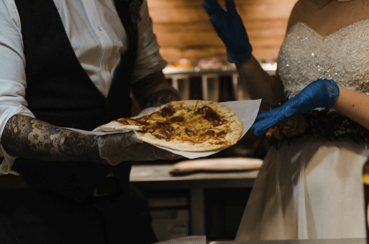 The couple participated in cooking pizza for the guests