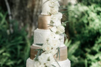 10 The wedding cake was a gold and white one topped with white ross and a calligraphy topper