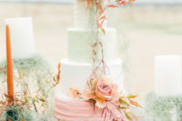 10 The wedding cake was done with four different layers – white, mint, pink, with unusual blooms for a statement