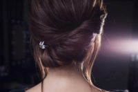 10 a chic twisted low chignon with some bangs down and a little rhinestone hairpiece for a modern bride
