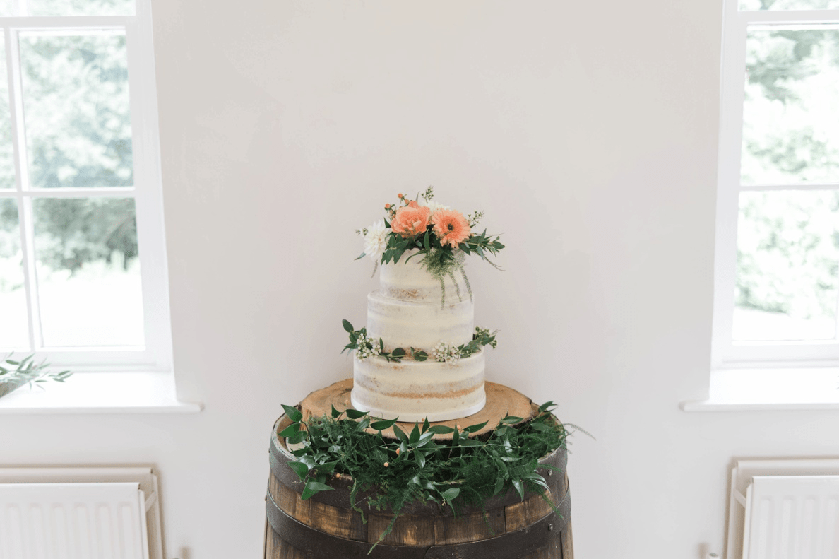 The wedding cake was a naked one decorated with greenery and blooms
