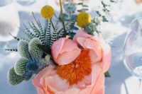 11 a bold centerpiece with a pink bloom, succulents, cacti, eucalyptus and billy balls