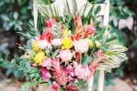 11 a tropical bouquet with yellow, pink and fuchsia blooms, greenery and tiny pink painted pineapples