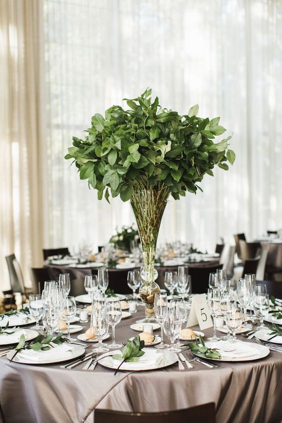 an elegant foliage wedding centerpieces and little green branches for each place setting