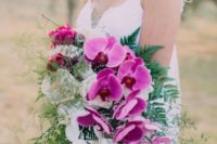 12 a colorful and vibrant wedding bouquet with hot pink and white orchids and textural greenery