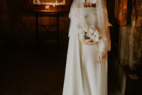 12 a modern off the shoulder dress with long sleeves with a small train, a veil and statement earrings to add a chic touch