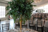 12 a tall greenery wedding centerpiece shaped as a ball on a tall gilded stand