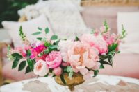 13 a bright floral centerpiece with blush, pink and hot pink flowers plus greenery