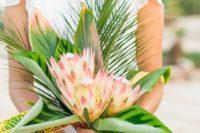 13 a simple and chic tropical bridal bouquet with three king proteas and tropical leaves