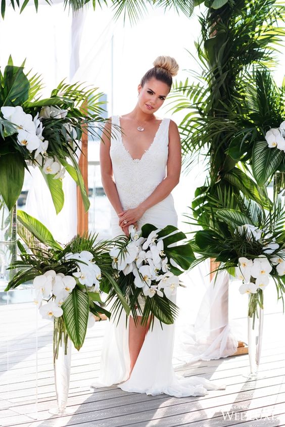 a chic tropical bouquet with white orchids and tropical leaves is a timeless idea