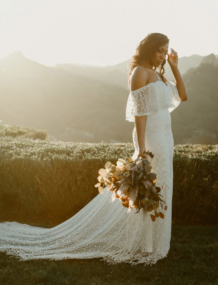 an amazing polka dot off the shoulder sheath wedding gown with a long train and sheer detailing