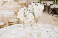 a glam tropical wedding centerpiece with white orchids is a chic idea