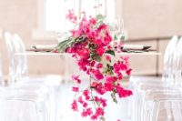 17 a modern tropical table runner with palm leaves and bold fuchsia blooms cascading down