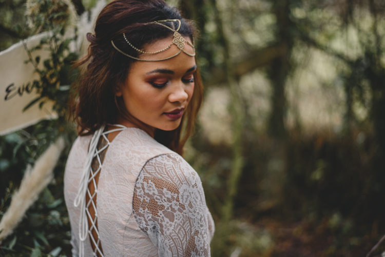 A gold boho chain headpeice with a pendant for a forest boho bride