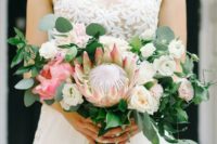 19 a lush graden wedding bouquet with a king protea, white penoies, pink blooms and much greenery