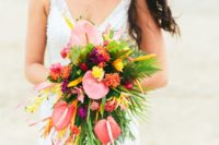 20 a cascading bouquet with much greenery, salmon pink, orange and yellow blooms