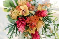 21 a cascading tropical wedding bouquet with fuchsia, yellow, orange blooms and greenery