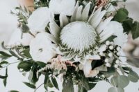 21a modern bouquet with a king protea, white blooms, thistles, baby’s breath and greenery