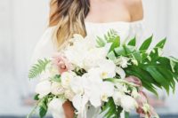 22 a chic cascading bouquet with white and light pink orchids and greenery for a romantic feel