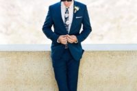 23 a stylish tropical groom look with a navy suit, a white shirt and a dark floral tie