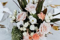 24 a tropical wedding centerpiece of roses, anemones, orchids and greenery and leaves