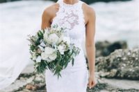 24 a white lace sheath wedding dress with an illusion neckline and a front slit for a sexy look