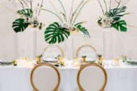 25 gorgeous tropical centerpieces with tropical blooms and palm leaves for a glam or art deco wedding