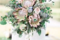 26 a wedding bouquet with king proteas, eucalyptus and greenery for a boho bride
