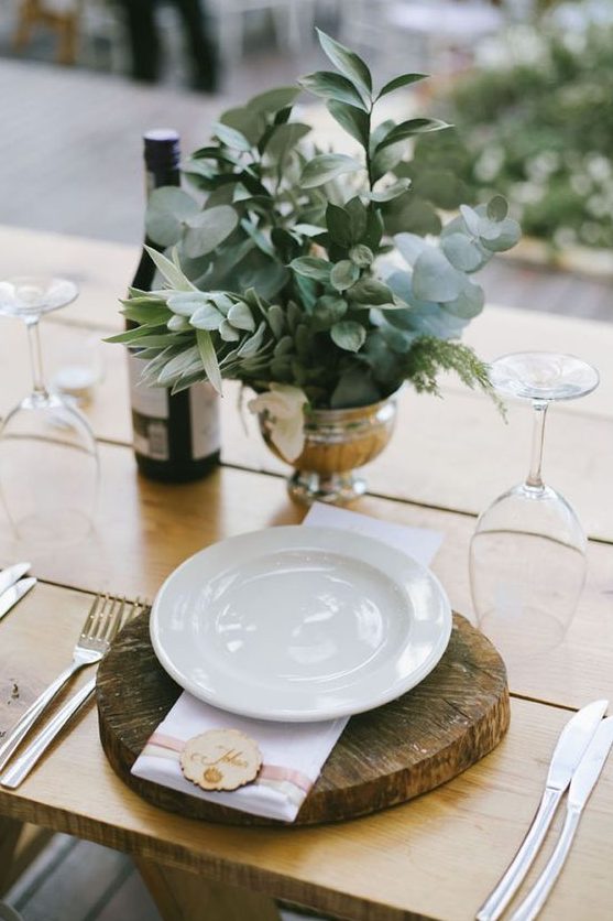 a beautiful wedding centerpiece of a silver bowl and some greenery of various kinds is ideal for a modern rustic wedding