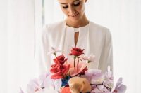 a bright wedding bouquet of blush orchids, red and white roses and anthurium is a unique idea for a modern bride