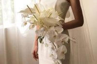 a cascading wedding bouquet of white anthurium and orchids is a chic and stylish idea for a modern wedding